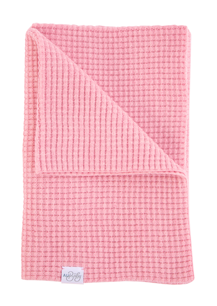 Light pink, superfine merino waffle-knit The Popcorn Blanket - Pink Quartz with one corner folded over.