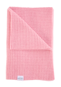 Light pink, superfine merino waffle-knit The Popcorn Blanket - Pink Quartz with one corner folded over.