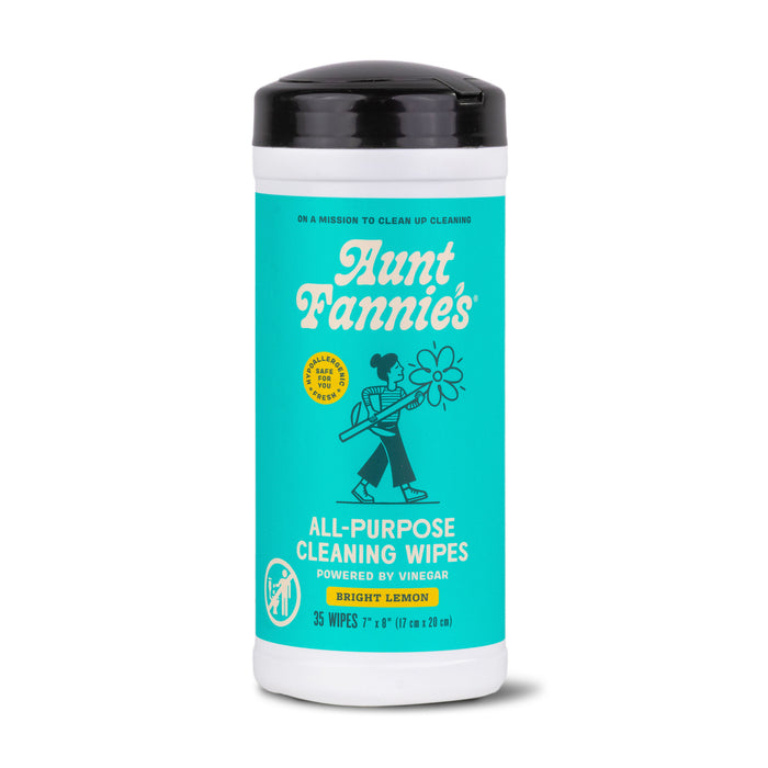 A cylindrical container of Aunt Fannies All-Purpose Cleaning Wipes in Bright Lemon scent, featuring a teal label with a person holding a flower and text describing the product.