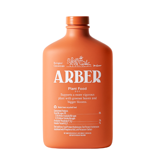 An orange bottle labeled ARBER Plant Food 2-2-1 with white text, featuring plant illustrations. The label mentions it’s a biological concentrate for indoor plants, supporting greener leaves and bigger blooms.