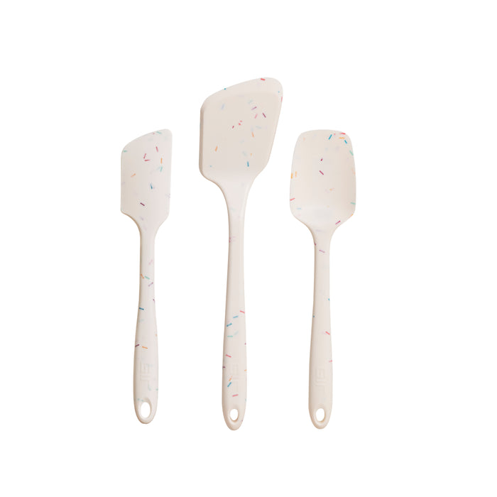 Three white silicone spatulas with colorful speckles, arranged vertically in increasing size against a plain background. The 3-Piece Ultimate Tool Set (Gift) from GIR offers heat-resistant silicone kitchen tools perfect for all your culinary adventures.