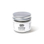 A small clear glass jar of Anima Mundi TOOTH POLISH, Fluoride Free, Net Wt. 2.5 oz / 71 g, with a silver lid on a white background, featuring a plant-based clay formula for naturally brighter smiles.