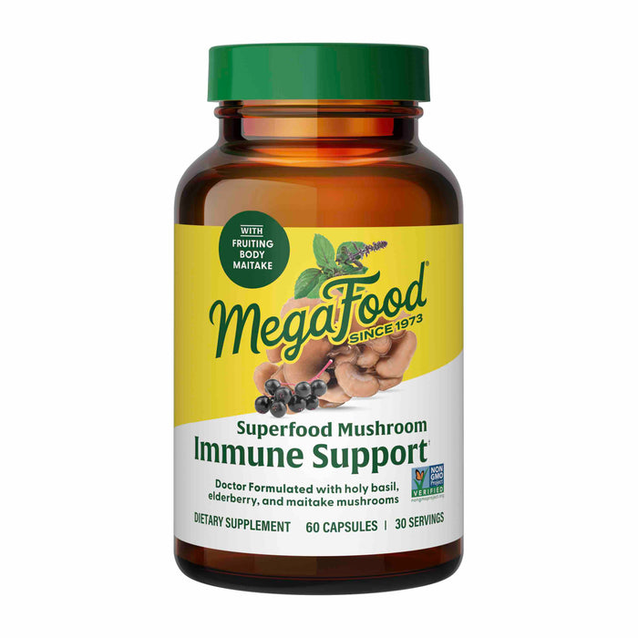 A brown bottle of MegaFood Superfood Mushroom Immune Support dietary supplement, featuring a green and yellow label with images of mushrooms, berries, and leaves. The bottle contains 60 capsules for immune support.