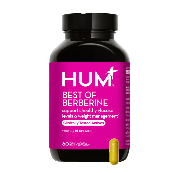 A bottle of HUM Best of Berberine dietary supplement with a bright pink label, featuring product details. A single yellow capsule is placed in front of the bottle. The bottle contains 60 vegan capsules.