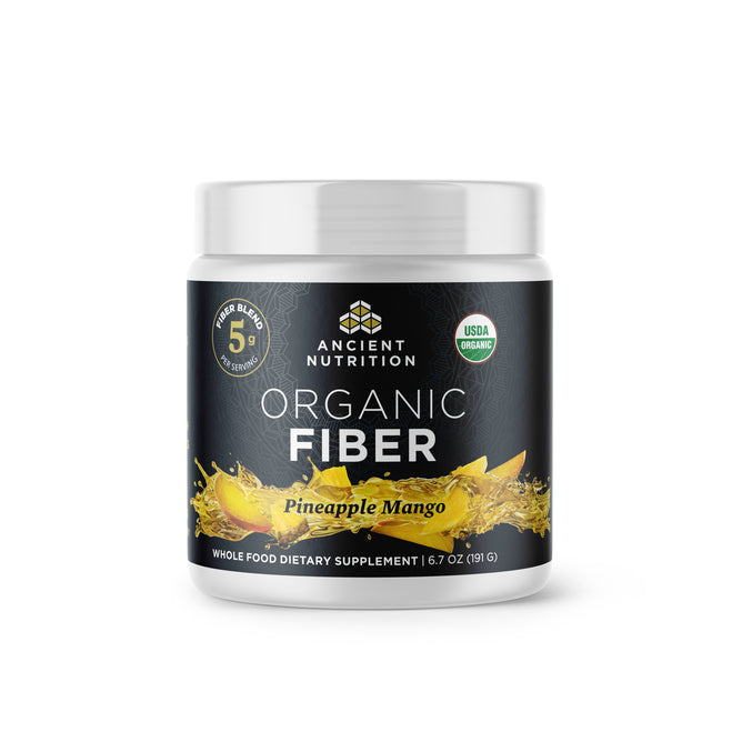 A container of Ancient Nutrition Organic Fiber dietary supplement, Pineapple Mango flavor. The black label features gold accents, fruit images, and icons highlighting 5g fiber per serving and USDA Organic certification.