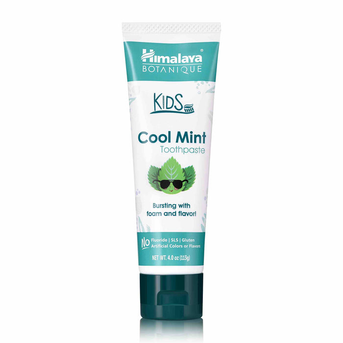 A tube of Himalaya Botanique Kids Cool Mint Toothpaste, featuring mint leaves with sunglasses on the label. The tube highlights that it has no fluoride, SLS, gluten, or artificial colors or flavors.