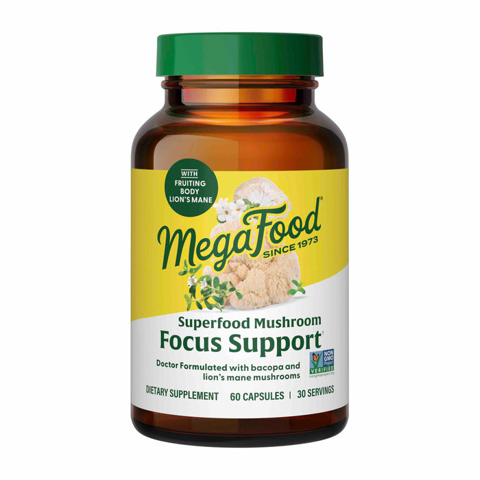 A brown bottle of MegaFood Superfood Mushroom Focus Support dietary supplement with a yellow label, showing images of mushrooms and herbs. The bottle contains 60 capsules and is labeled non-GMO and vegan.