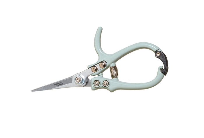 A pair of light green pruning shears with a curved handle, metal blades, and a spring mechanism, isolated on a white background.
