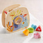 HABA Underwater World Wooden Shaper Sorter Toy featuring a magnifying glass center and four colorful wooden blocks shaped like a seahorse, turtle, starfish, and crab for toddlers.