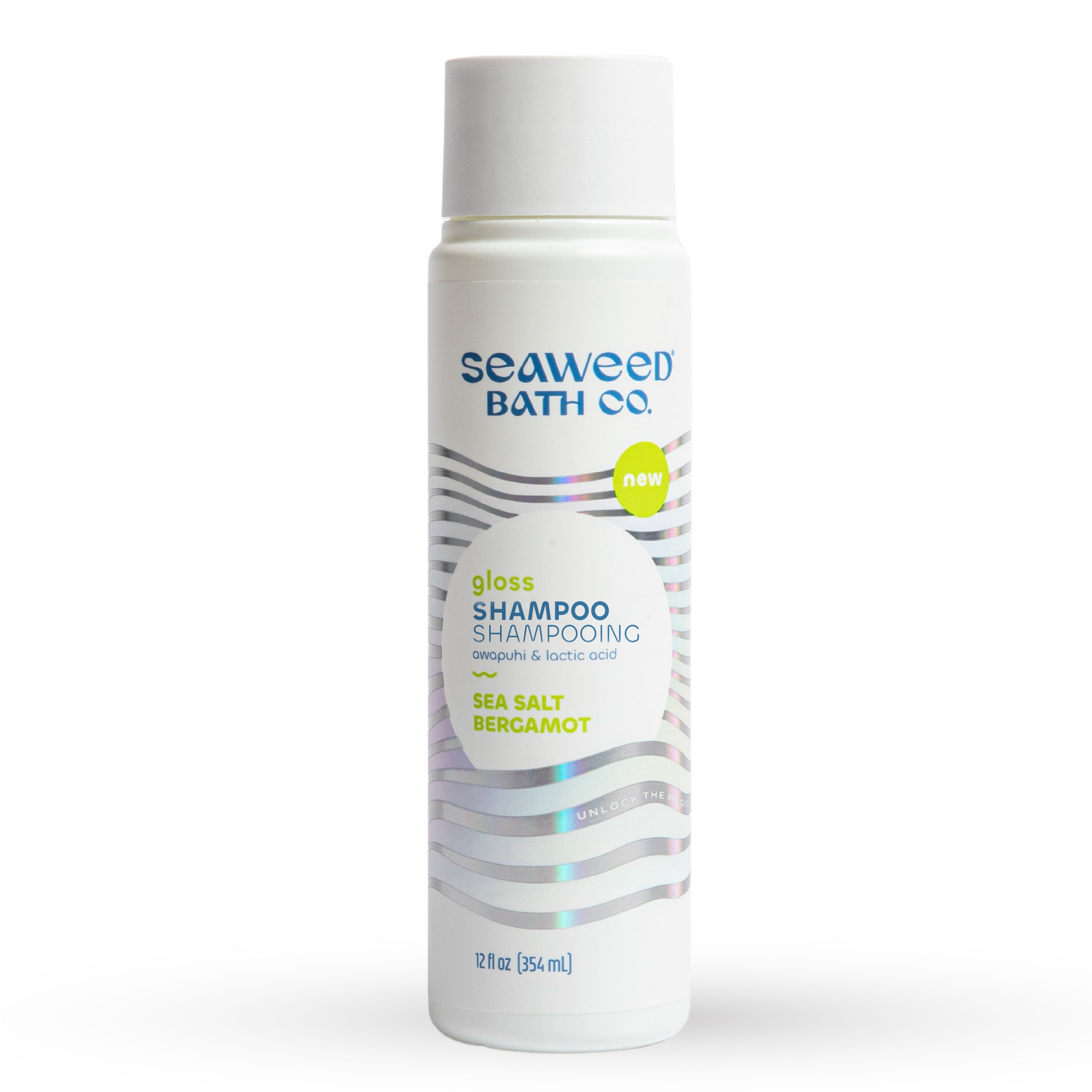 The Seaweed Bath Cos Gloss Shampoo in a white 12 oz (354 ml) bottle features a radiance-boosting blend of sea salt and bergamot, with replenishing amla and lactic acid. The sleek design includes purple and blue wavy label lines.