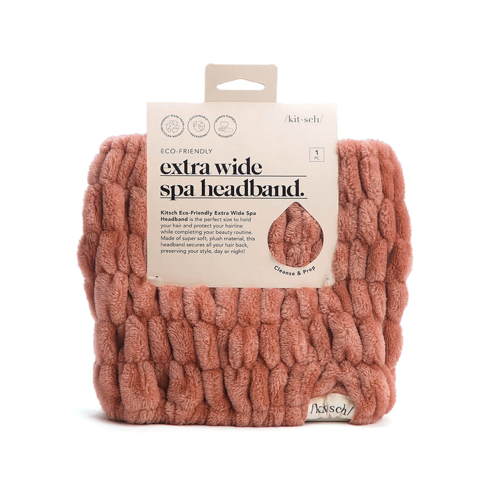A thick, textured pink headband is shown in its packaging labeled Kitsch Eco-Friendly Extra Wide Spa Headband, made from recycled materials and designed for use during skincare and makeup routines.