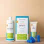 Oxyfresh dental care products for pets, including a bottle of water additive, a dental kit box, a tube of pet toothpaste, and several blue finger toothbrushes, displayed on a wooden surface against a beige background.