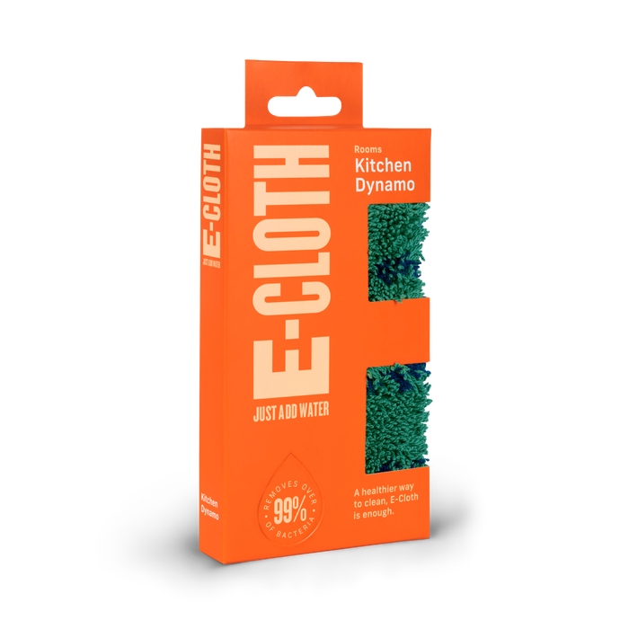 Bright orange E-Cloth Kitchen Dynamo packaging with a cutout showing a green textured cleaning cloth inside. Text highlights its effectiveness at removing 99% of bacteria with just water.