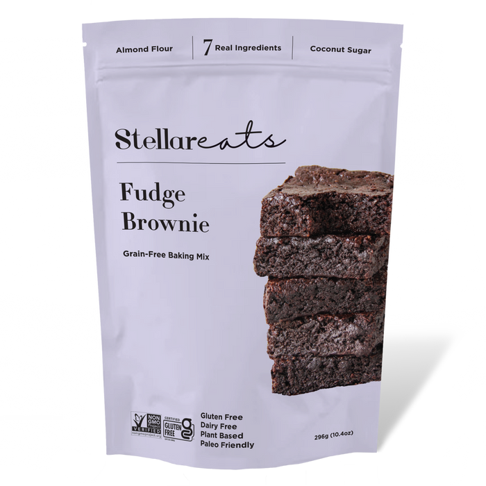 A white pouch of Stellareats Fudge Brownie grain-free baking mix, featuring a stack of brownies and labels indicating it is gluten free, dairy free, plant based, paleo friendly, and made with 7 real ingredients.