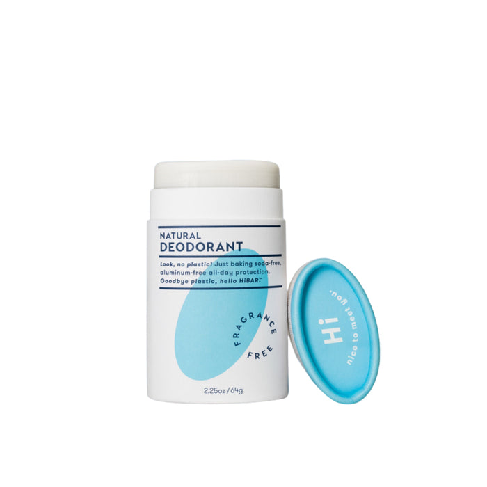 A white tube of natural deodorant with a blue label and a blue cap placed to the right. The label states FRAGRANCE FREE and includes product details in blue text. The cap says Hi and nice to meet you.
