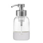 A clear glass soap dispenser with a silver pump top and a white silicone base. The word SOAP is printed on the lower part and WATER is marked near the tube inside the dispenser.