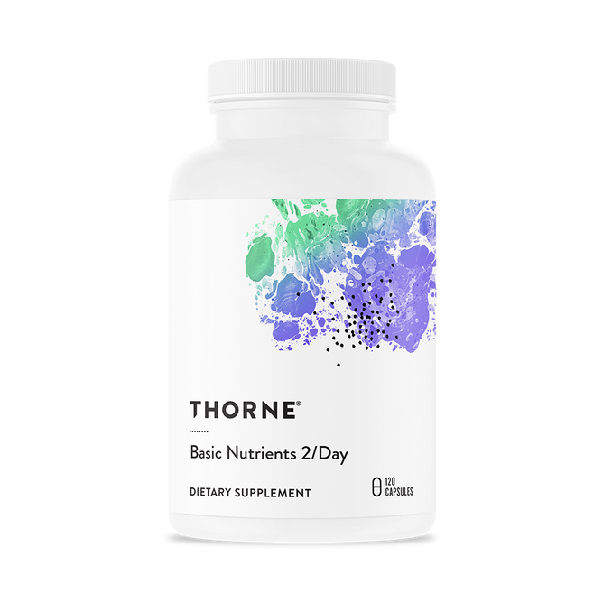 A white bottle of Thorne Basic Nutrients 2/Day daily multivitamin featuring abstract green and purple artwork on the label; contains 120 capsules.