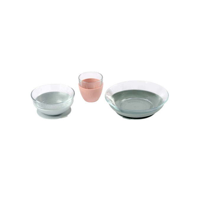 Three glass containers are shown: two contain clear liquid and one, in the center, contains a pink liquid. The containers are placed side by side on a white background.
