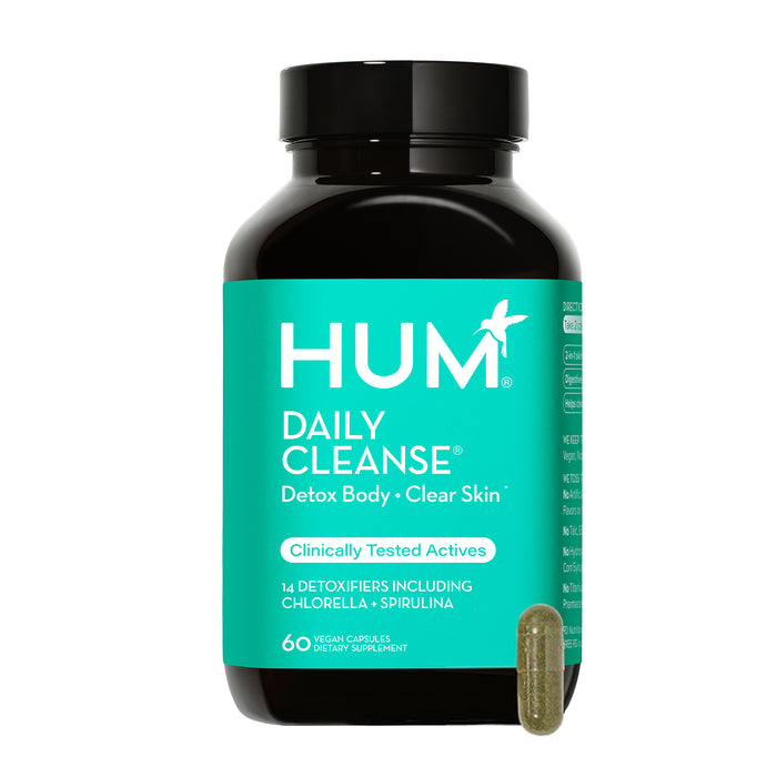 A bottle of HUM Daily Cleanse dietary supplement featuring a turquoise label and black lid, with one green capsule displayed in front. The label highlights detox body, clear skin, and 60 vegan capsules.