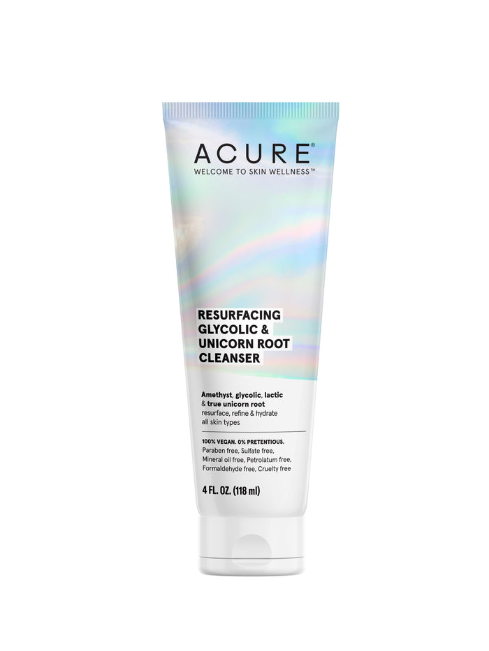 A tube of Acure Resurfacing Glycolic & Unicorn Root Cleanser, 4 fl oz, with an iridescent label. The product is for all skin types and is 100% vegan and free of parabens, sulfates, and formaldehyde.