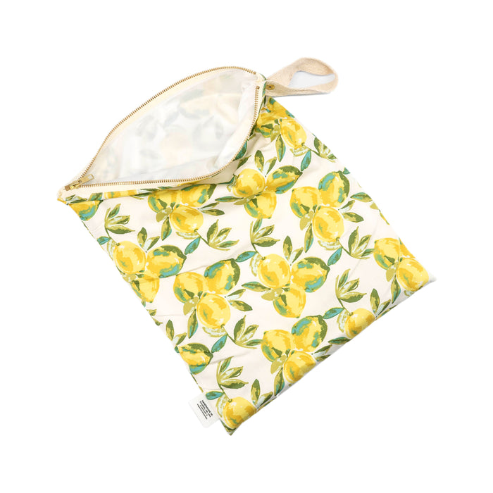 A reusable fabric bag with a zipper, featuring a colorful lemon and green leaf pattern on a white background. The bag is partially open, showing its spacious interior.