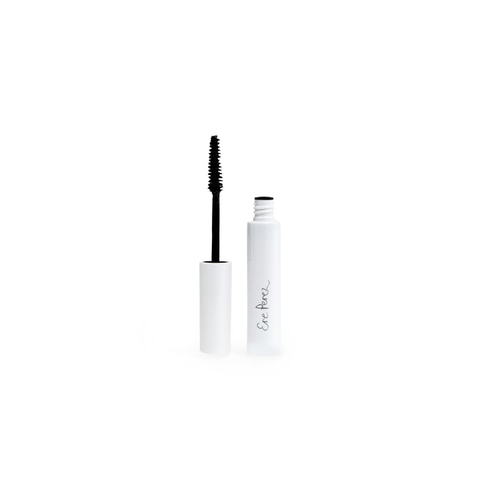 A white tube of mascara with the wand applicator removed and standing upright beside it; the tube has Ere Perez written on it in gray cursive text.