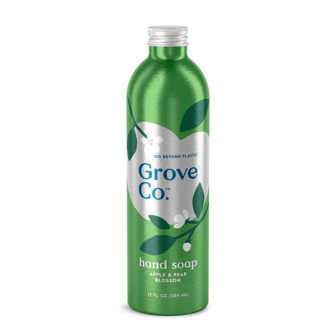 Grove Co.s Hydrating Hand Soap Refill, in a 13 fl oz (384 ml) recyclable aluminum bottle, boasts an apple & pear blossom scent. Made from plant-based ingredients, it features a leaf and blossom design and carries the eco-friendly slogan Go beyond plastic at the top.