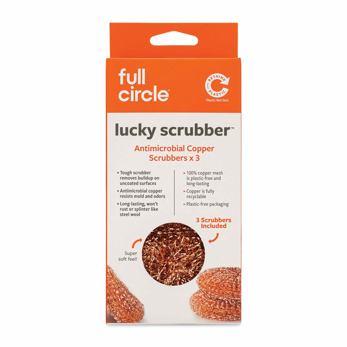 The image shows a package of Full Circle lucky scrubber antimicrobial copper scrubbers. The orange and white packaging highlights that it contains 3 scrubbers, and lists features like odor resistance and plastic-free packaging.