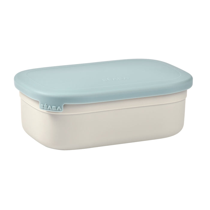 A rectangular food storage container with a light blue lid and an off-white base, featuring the brand name BÉABA embossed on one corner of the lid.