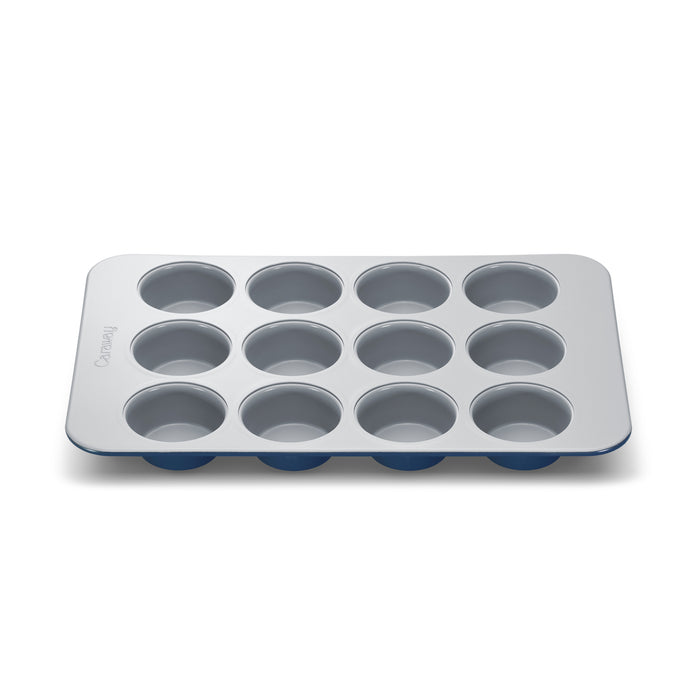 A silver 12-cup muffin tin with a nonstick surface, viewed from above on a plain white background.