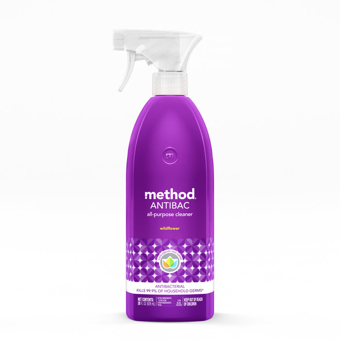 A purple spray bottle of Method Antibac all-purpose cleaner in wildflower scent, with a white trigger and a geometric patterned label, standing upright on a white background.