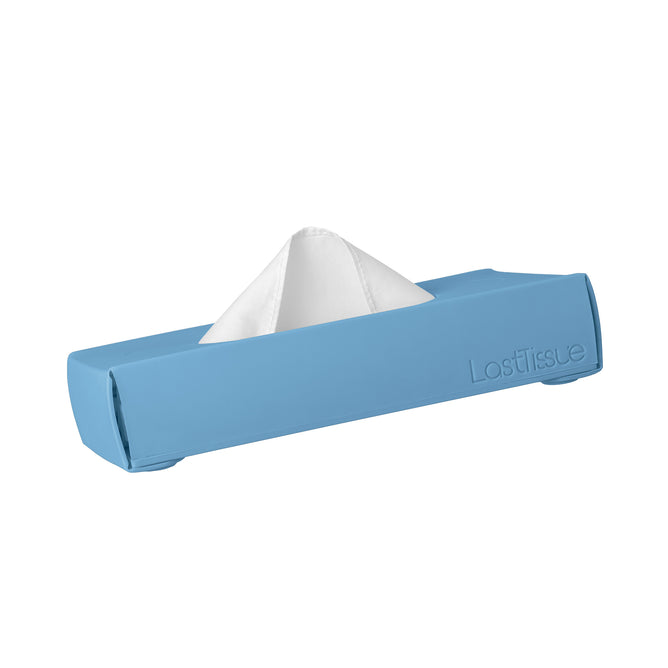 A LastObject blue LastTissue box with a white tissue partially pulled out, housed in a sleek silicone design with the brand name embossed on the side. This eco-friendly tissue case holds organic cotton tissues for a sustainable touch.