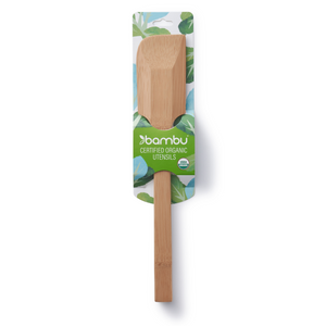 The Scraping Spatula by Bambu, an eco-friendly kitchen utensil made from certified organic bamboo, features a straight edge and is packaged on a card decorated with green and blue leaf designs.
