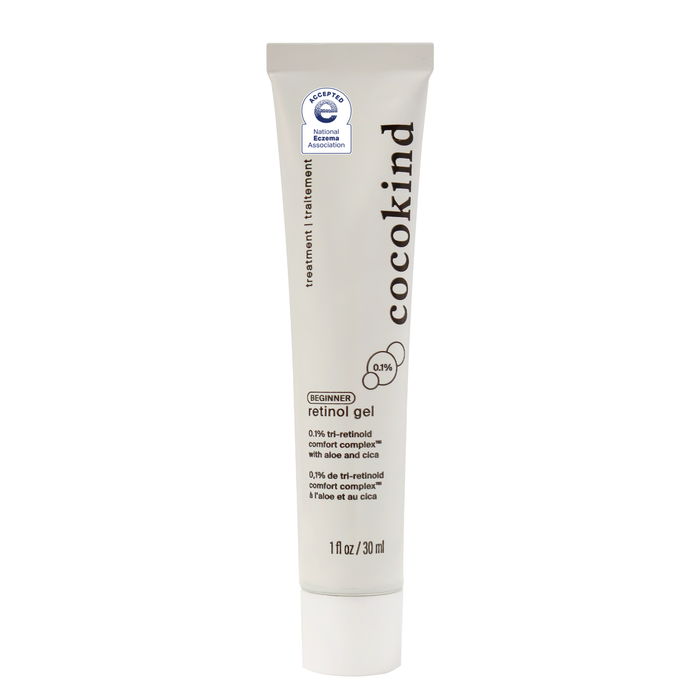 A white tube of Cocokind retinol gel with black text, showing the product name, BEGINNER retinol gel, ingredient details, and a blue seal from the National Eczema Association. The tube contains 1 fl oz (30 ml).