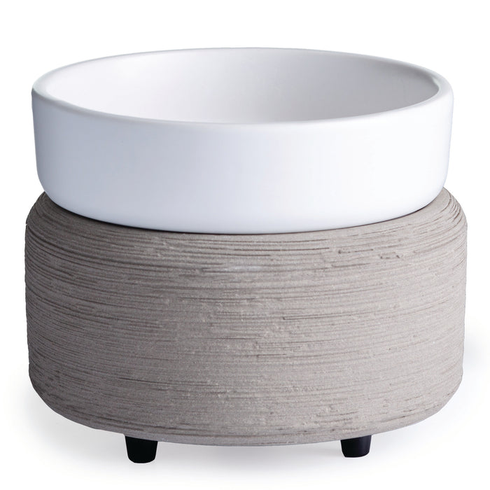 A white ceramic bowl rests on a textured, round, gray raised stand with three small black feet.