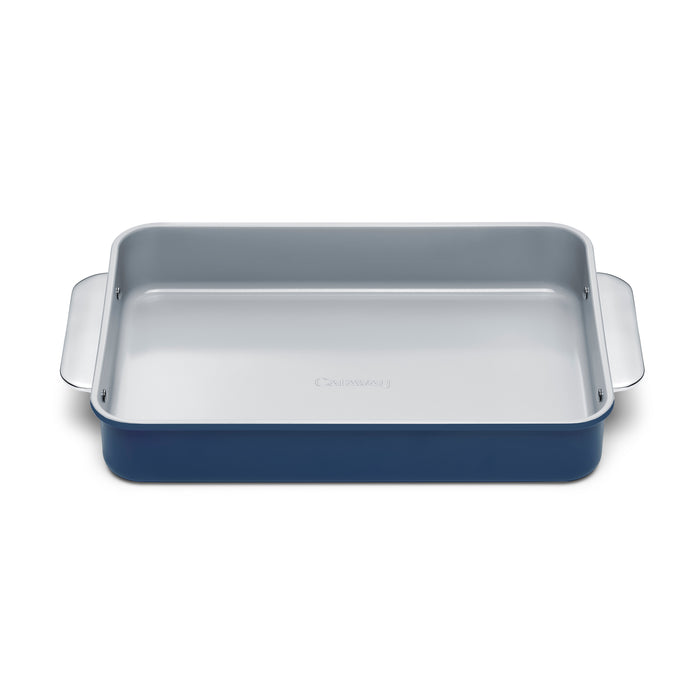 A rectangular blue baking pan with a light gray nonstick interior and two wide handles, shown on a white background.
