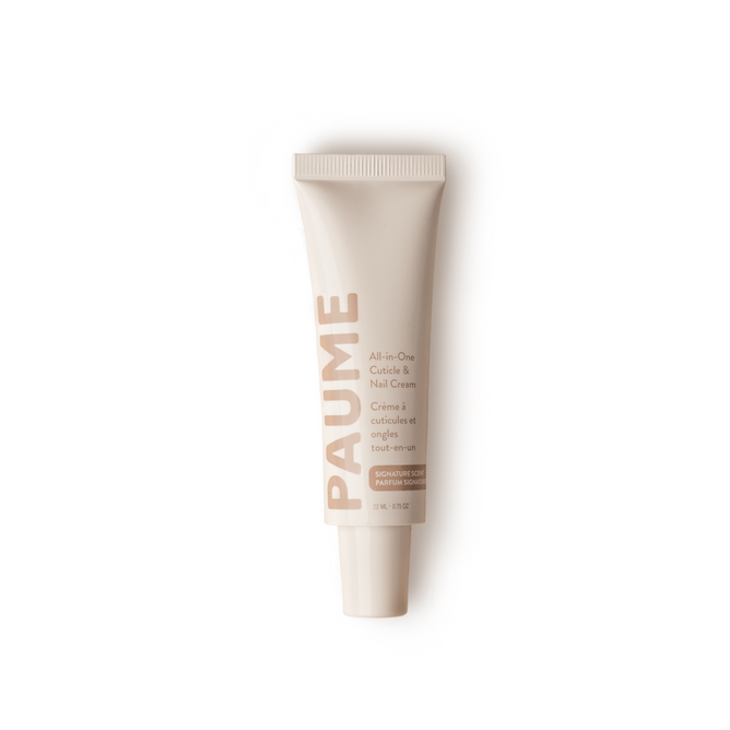A white tube labeled PAUME, standing upright against a white background, reads All-in-One Cuticle & Nail Cream and is enriched with plant keratin for nourishment.