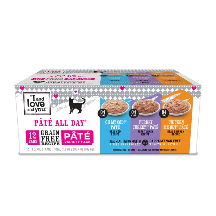 A box of I and love and you Paté All Day grain free cat food variety pack, showing 12 cans in 3 flavors: Oh My Cod!, Purrky Turkey, and Chicken Me Out, each with images of the food and playful cat graphics.