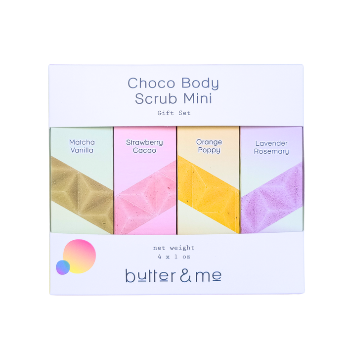 A gift set of four Choco Body Scrub Minis by butter & me, with colorful packaging labeled Matcha Vanilla, Strawberry Cacao, Orange Poppy, and Lavender Rosemary, in a white box.