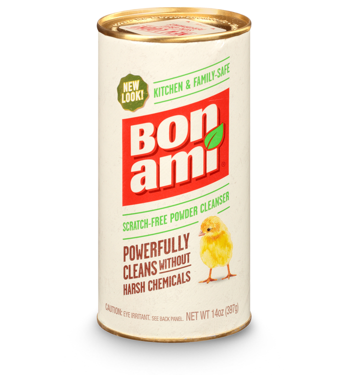 A cylindrical container of Bon Ami scratch-free powder cleanser featuring a yellow chick illustration and text promoting its powerful cleaning ability without harsh chemicals. The net weight is 14 oz (397 g).