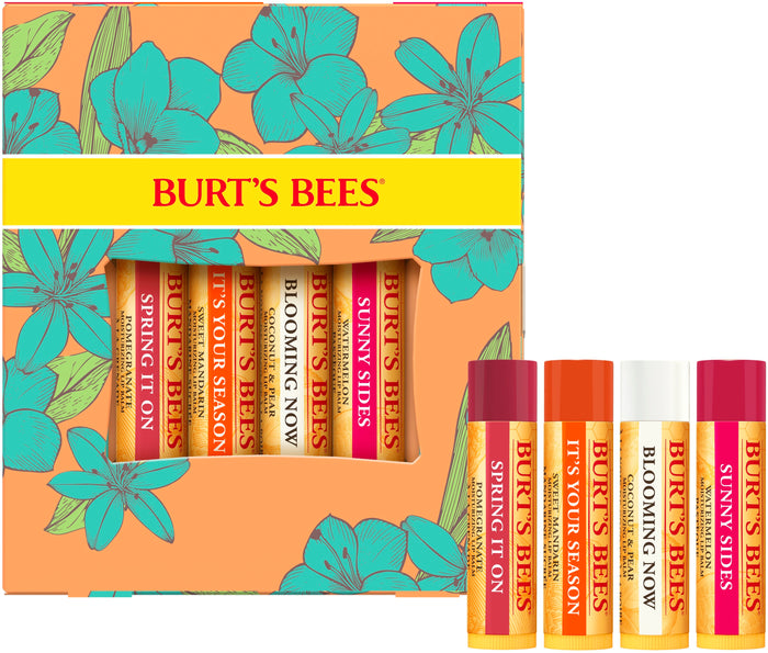 A Burt’s Bees lip balm gift set with a floral-patterned box containing four tubes labeled Spring It On, It’s Your Season, Blooming Now, and Sunny Sides. The tubes are shown both inside and outside the box.