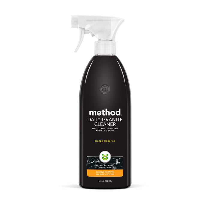 A bottle of Method Daily Granite Cleaner in orange tangerine scent, with a white spray nozzle, black bottle, and white text. The label indicates it cleans granite, marble, and stone surfaces.