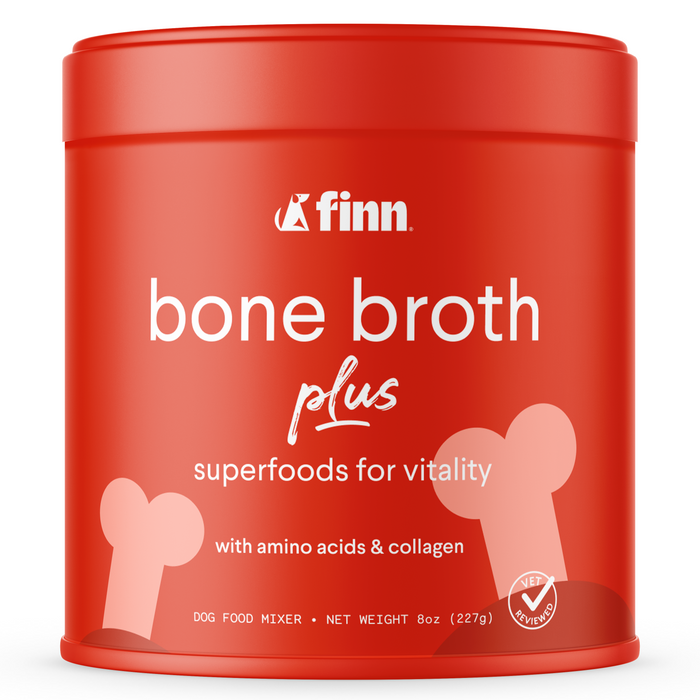 A red container of Finn Bone Broth Plus for dogs, labeled superfoods for vitality with amino acids and collagen. The package features bone illustrations and white text on the front.