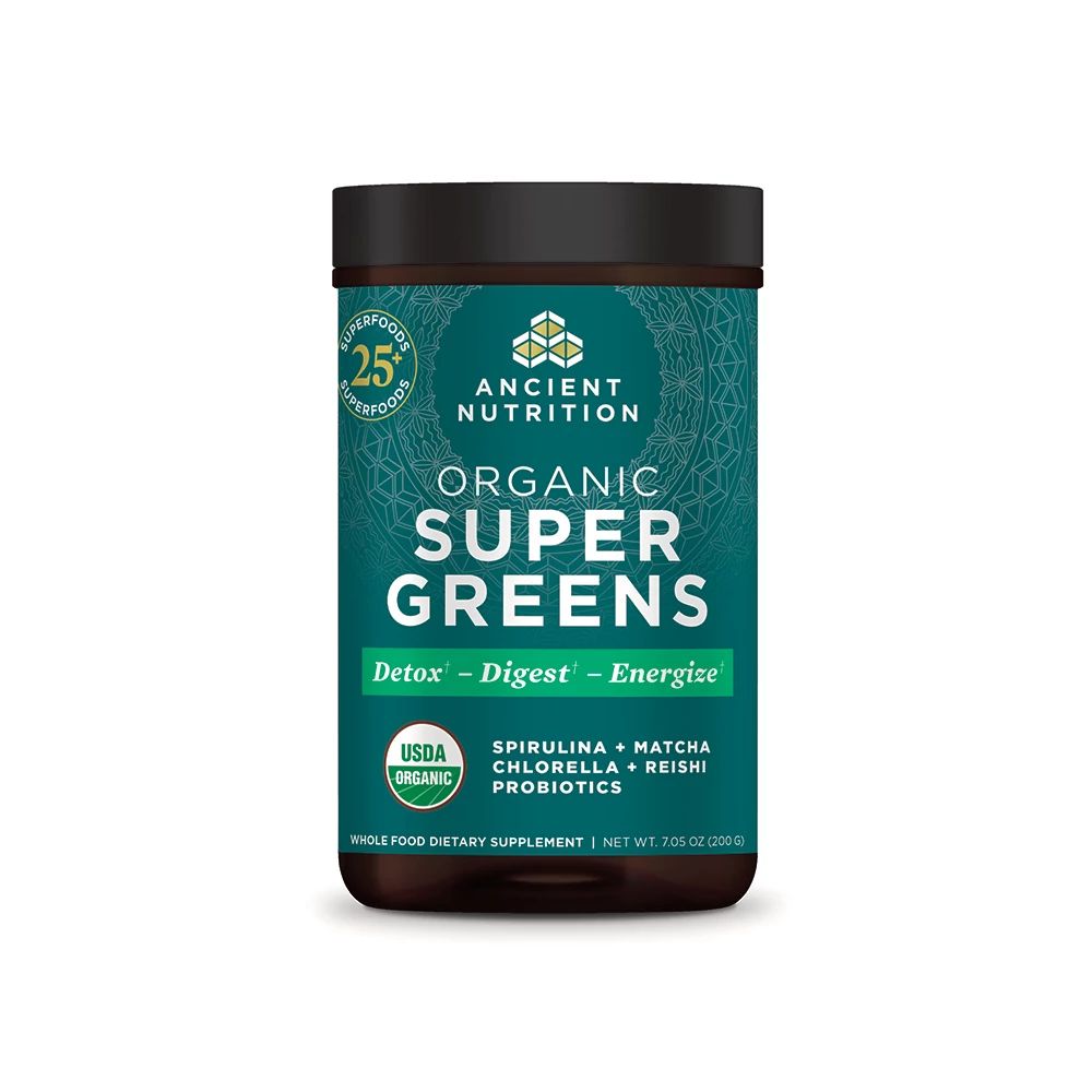 A container of Ancient Nutrition Organic Super Greens powder with a green and black label, highlighting benefits like Detox, Digest, and Energize and ingredients such as spirulina, matcha, chlorella, reishi, and probiotics.