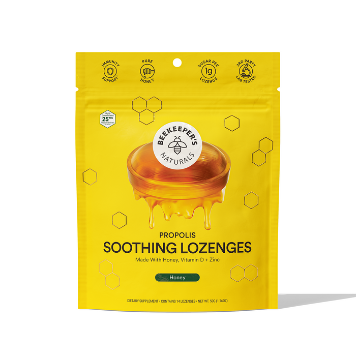 A yellow resealable pouch of Beekeeper’s Naturals Propolis Soothing Lozenges, featuring a honey dipper with honey, hexagon designs, and text highlighting ingredients like honey, vitamin D, and zinc.