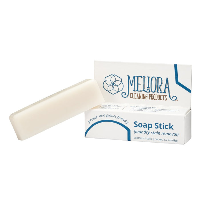 A white soap stick rests on a partially open box labeled Meliora Cleaning Products Soap Stick (laundry stain removal). The packaging highlights that the product is people- and planet-friendly.