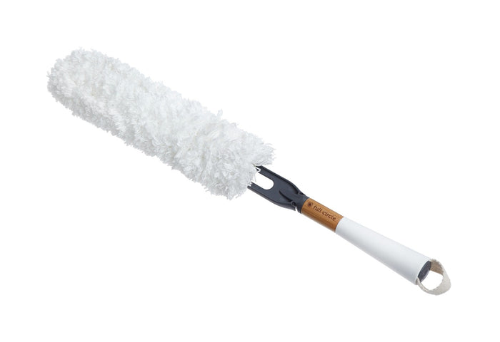 A fluffy white duster with a black and wood handle, featuring a white hanging loop at the end.