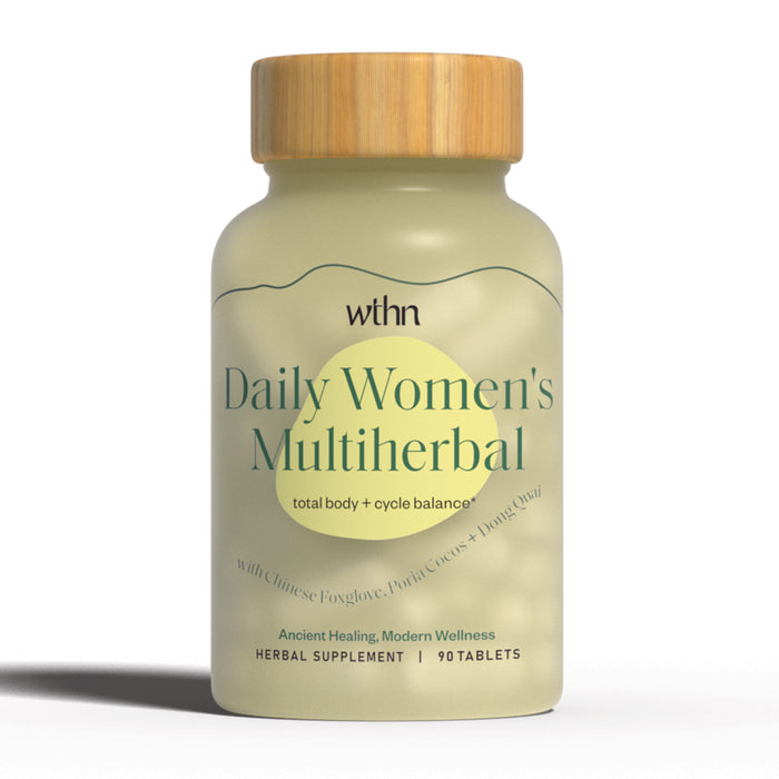 A beige bottle with a wooden cap labeled Daily Women’s Multiherbal by WTHN, described as a herbal supplement with cycle balance, containing 90 tablets. The label mentions Chinese Foxglove, Poria Cocos, and Dong Quai.