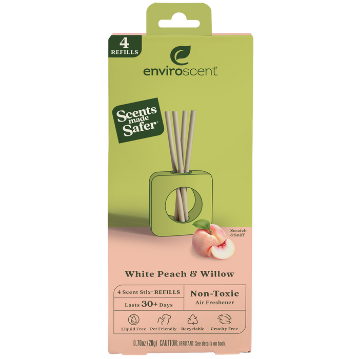A green and peach-colored box of Enviroscent White Peach & Willow air freshener refills. The packaging shows reed diffusers, a peach, and text highlighting its non-toxic, recyclable, liquid-free, and long-lasting features.