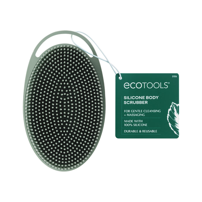 An oval-shaped EcoTools silicone body scrubber with textured bristles, a handle, and a green tag attached that reads: EcoTools Silicone Body Scrubber for gentle cleansing & massaging, made with 100% silicone, durable & reusable.